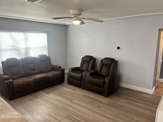 living room with ceiling fan, hardwood / wood-style floors, and a textured ceiling