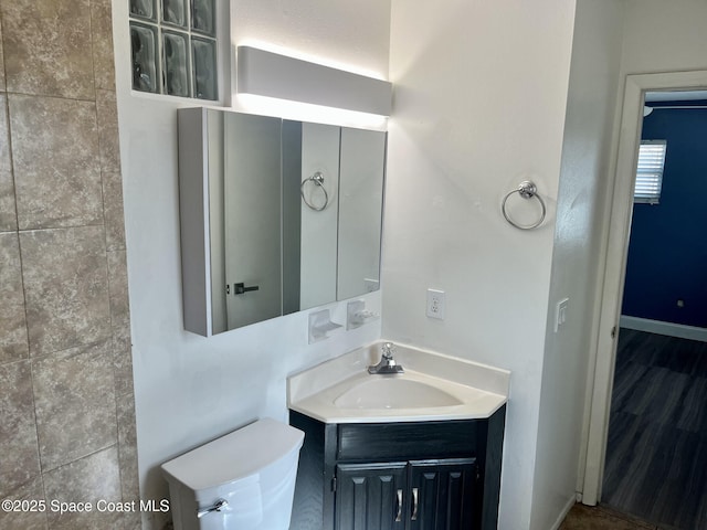 bathroom featuring vanity and toilet