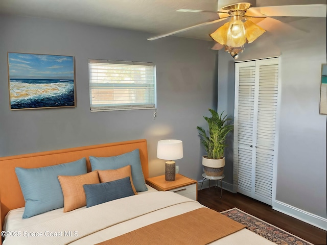 bedroom featuring dark hardwood / wood-style flooring, a closet, and ceiling fan