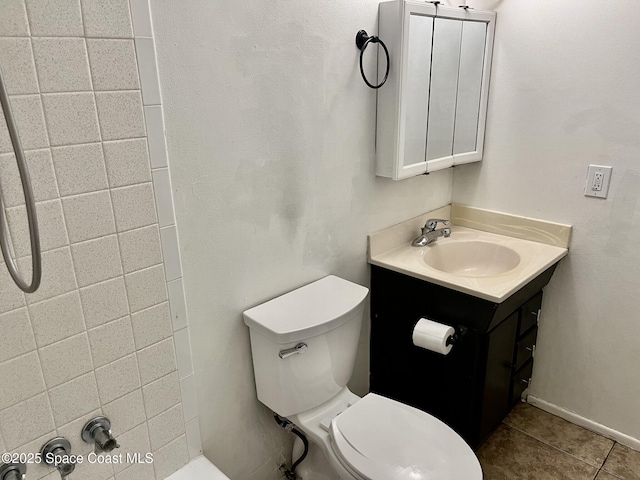 bathroom featuring vanity, tile patterned floors, and toilet