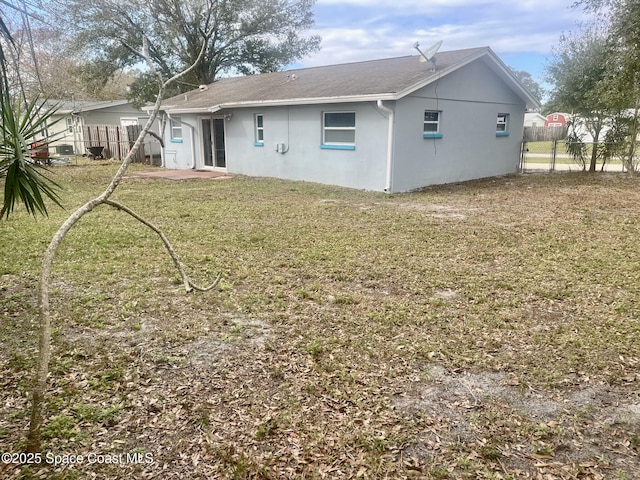 back of house featuring a lawn