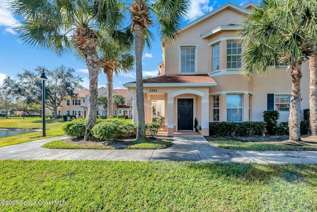 mediterranean / spanish home with a front yard