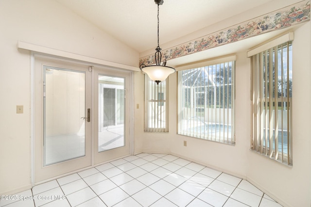 unfurnished dining area with vaulted ceiling and french doors