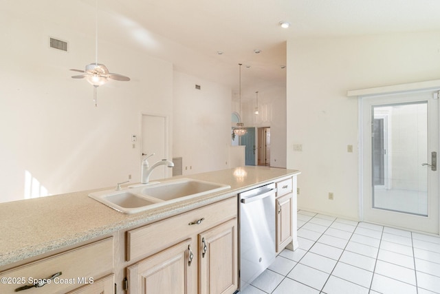 kitchen with sink, hanging light fixtures, light tile patterned floors, light brown cabinets, and dishwasher