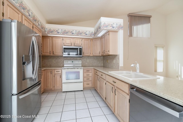 kitchen with lofted ceiling, sink, light brown cabinets, and appliances with stainless steel finishes