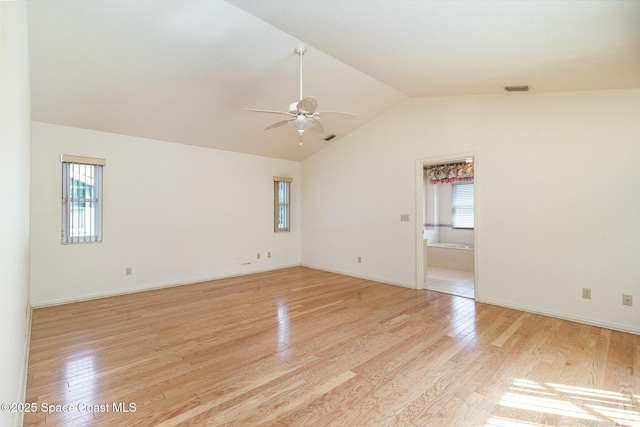 spare room featuring ceiling fan, vaulted ceiling, and light hardwood / wood-style floors