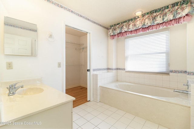 bathroom with vanity, tile patterned flooring, and a bathtub