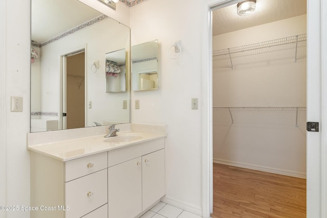 bathroom featuring hardwood / wood-style flooring and vanity