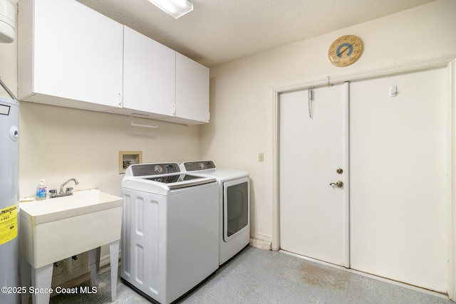 laundry area with sink, washer and clothes dryer, and cabinets