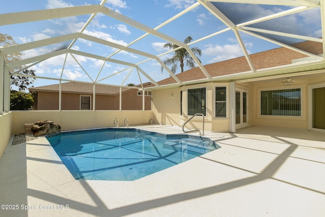 view of swimming pool featuring a lanai, a patio, and ceiling fan