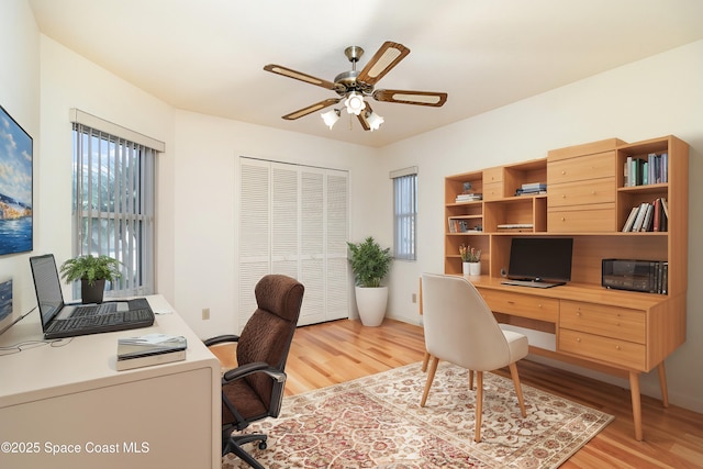 office with ceiling fan, plenty of natural light, and light hardwood / wood-style floors