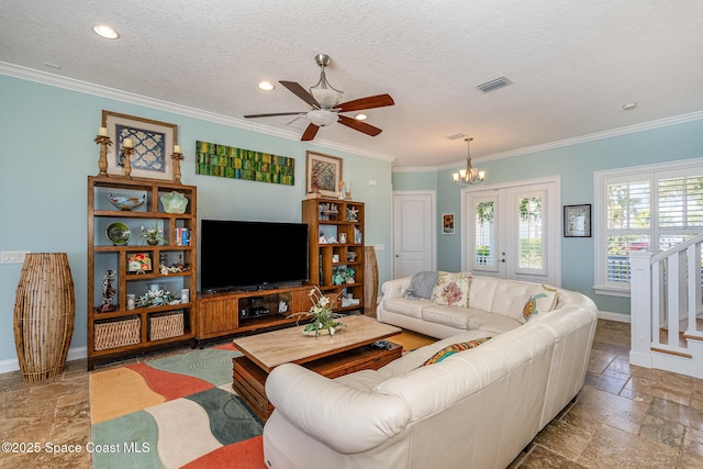 living room featuring crown molding, ceiling fan with notable chandelier, and a textured ceiling