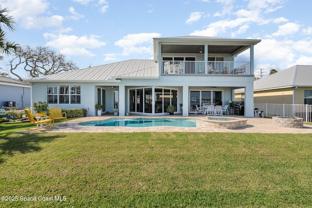 back of property featuring a pool with hot tub, a balcony, a patio, and ceiling fan