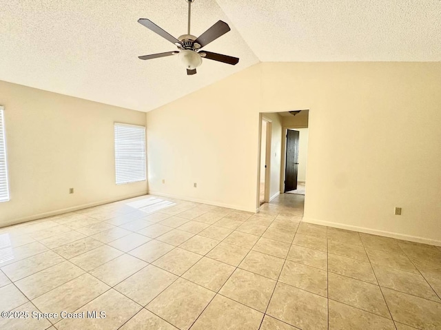 unfurnished room with a ceiling fan, vaulted ceiling, a textured ceiling, and light tile patterned floors