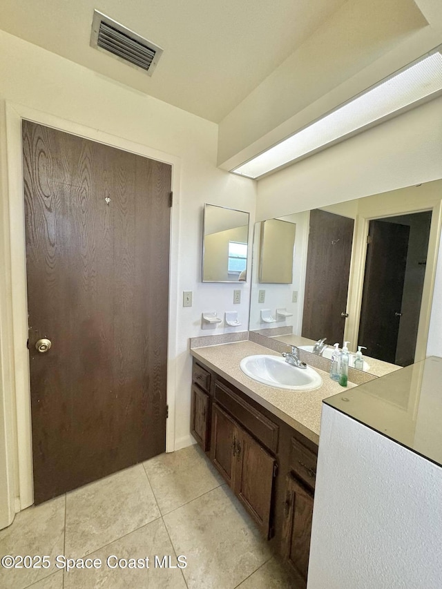 bathroom featuring tile patterned flooring and vanity