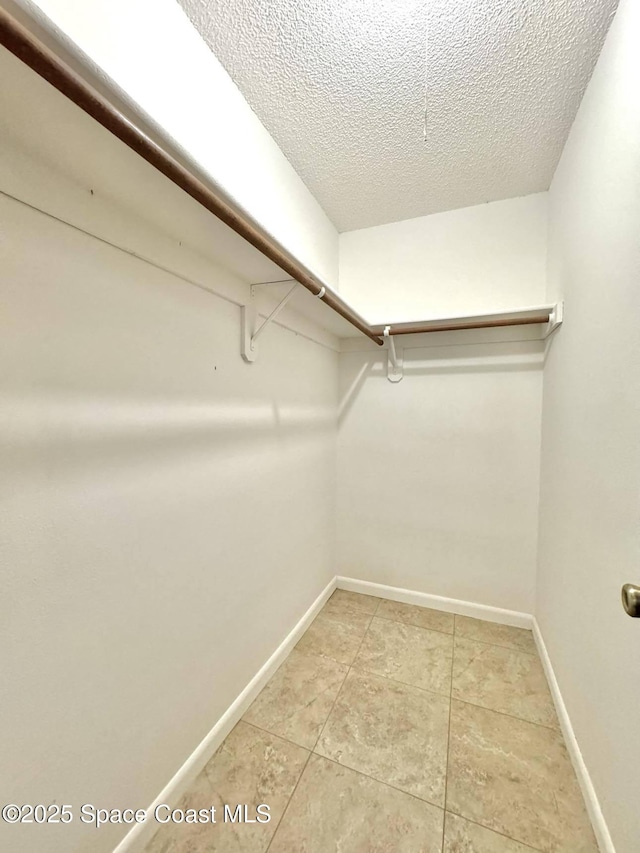 spacious closet featuring tile patterned floors