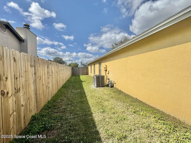 view of yard featuring fence and cooling unit