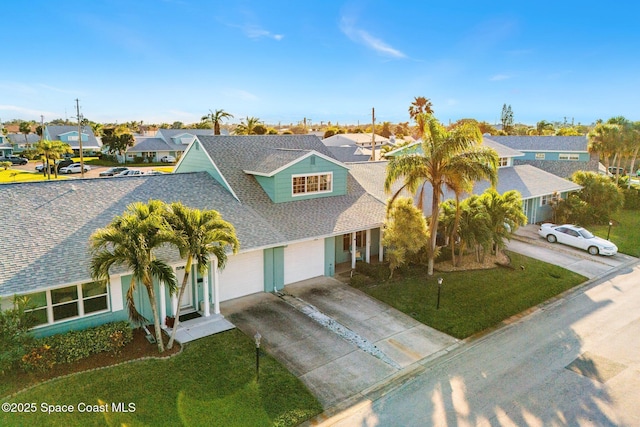 view of front of home featuring a garage and a front lawn