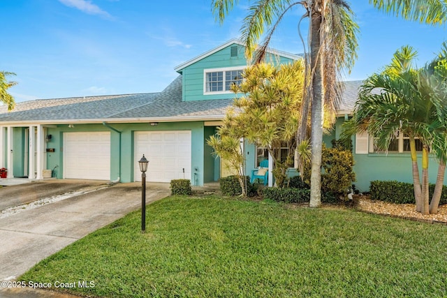 view of front facade with a garage and a front yard