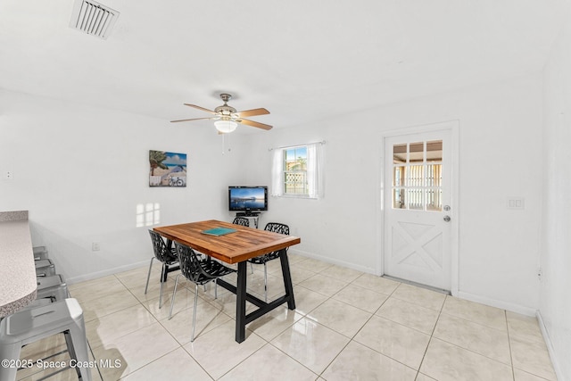 tiled dining area with ceiling fan