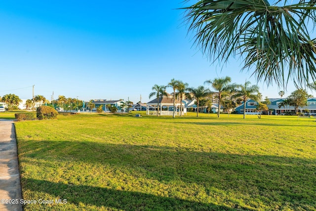 view of property's community with a lawn