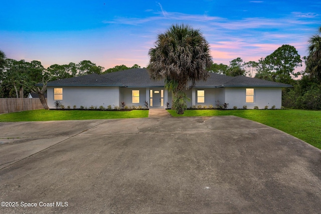 ranch-style house with a yard