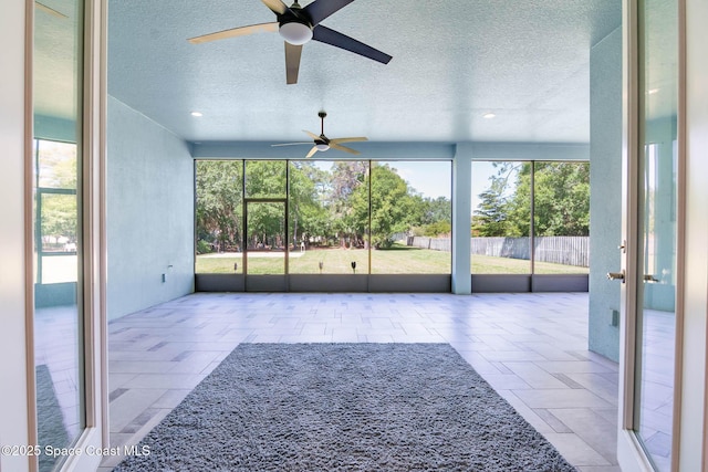 unfurnished living room with ceiling fan, a textured ceiling, and recessed lighting