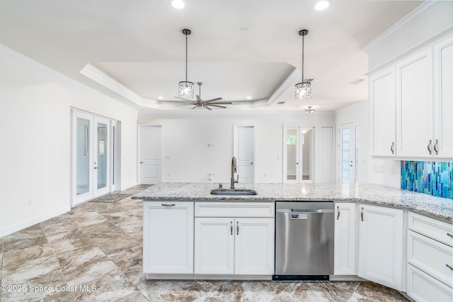 kitchen featuring a sink, stainless steel dishwasher, white cabinets, a tray ceiling, and ornamental molding