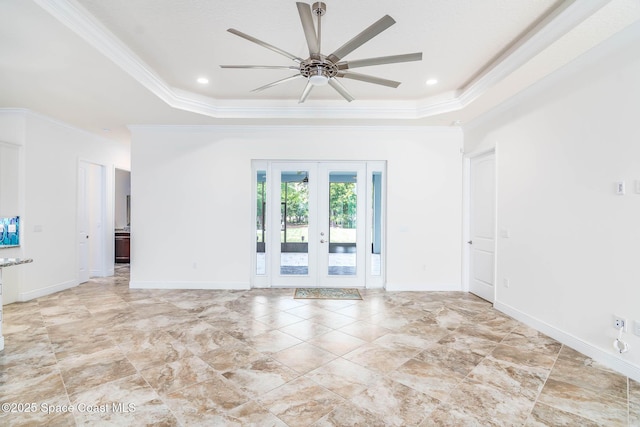 unfurnished room with a raised ceiling, crown molding, french doors, ceiling fan, and baseboards