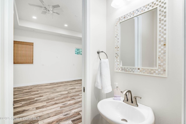 bathroom featuring a sink, wood finished floors, ceiling fan, recessed lighting, and baseboards
