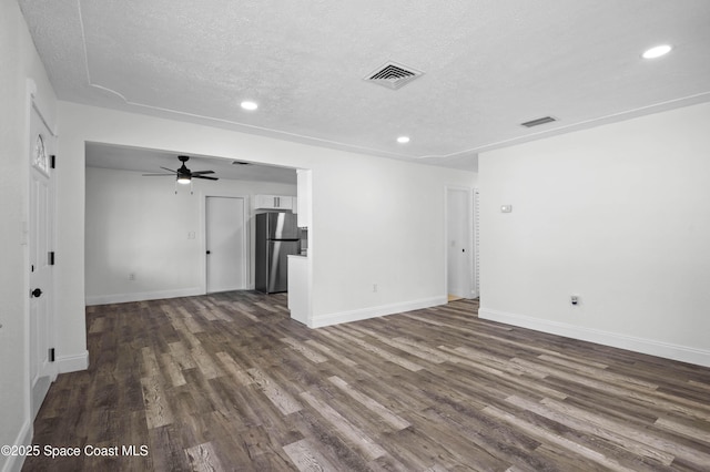 unfurnished room featuring ceiling fan, dark hardwood / wood-style floors, and a textured ceiling