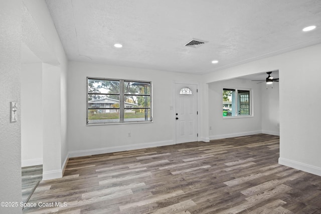 foyer with wood-type flooring and a textured ceiling