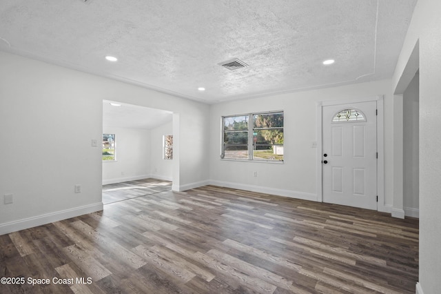 foyer entrance featuring dark hardwood / wood-style floors and a textured ceiling