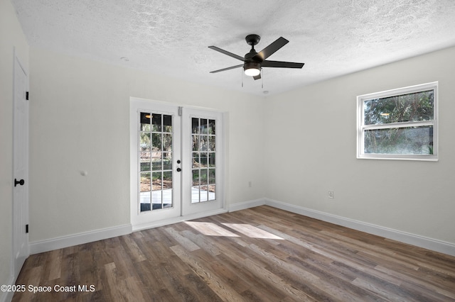 spare room with hardwood / wood-style floors, french doors, a textured ceiling, and ceiling fan