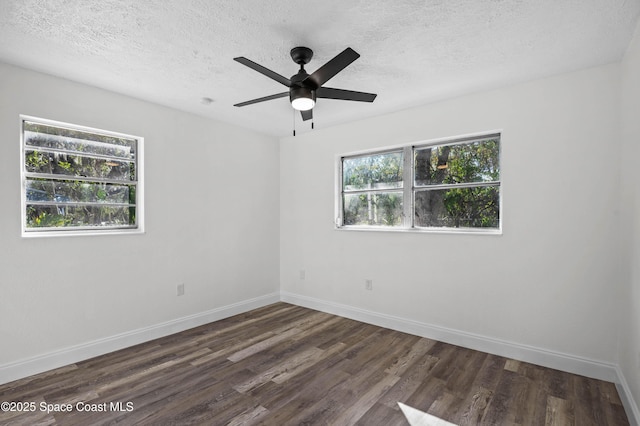 spare room with ceiling fan, dark wood-type flooring, and a textured ceiling