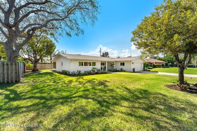 view of front of house featuring a garage and a front lawn