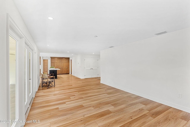 unfurnished room with light wood-type flooring