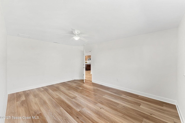 spare room featuring ceiling fan and light wood-type flooring