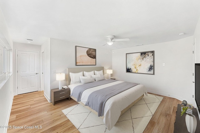 bedroom with light hardwood / wood-style floors and ceiling fan