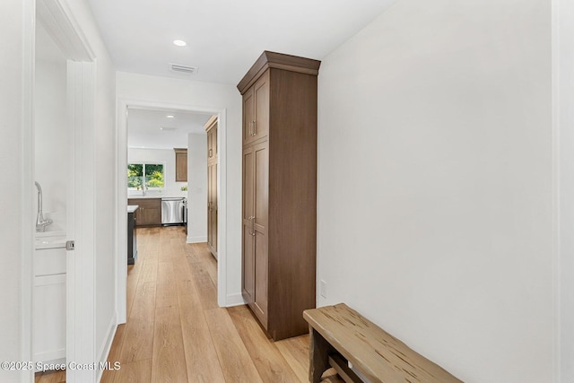 hallway with light hardwood / wood-style floors