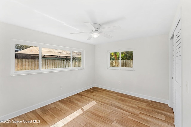 unfurnished bedroom with ceiling fan, light hardwood / wood-style floors, and a closet