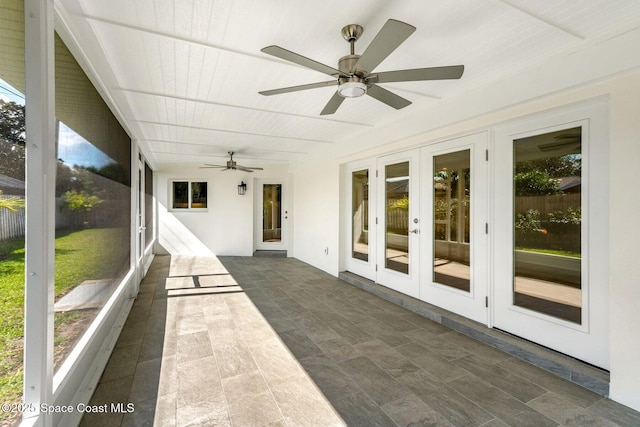 unfurnished sunroom featuring french doors and a healthy amount of sunlight