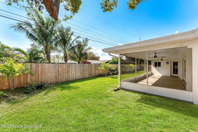 view of yard with ceiling fan and a patio area