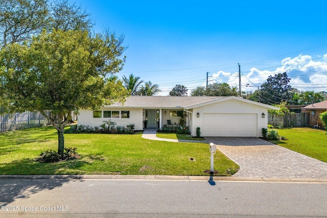 single story home with a garage and a front lawn