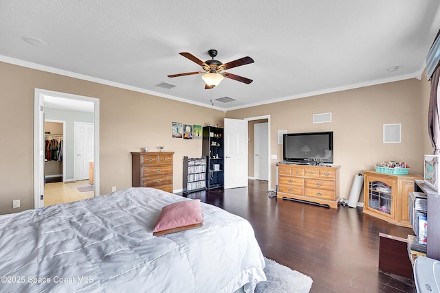 bedroom with ceiling fan, wood-type flooring, ornamental molding, and a textured ceiling