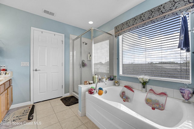 bathroom with tile patterned floors, independent shower and bath, and vanity