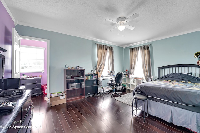 bedroom with ceiling fan, ornamental molding, dark wood-type flooring, and a textured ceiling