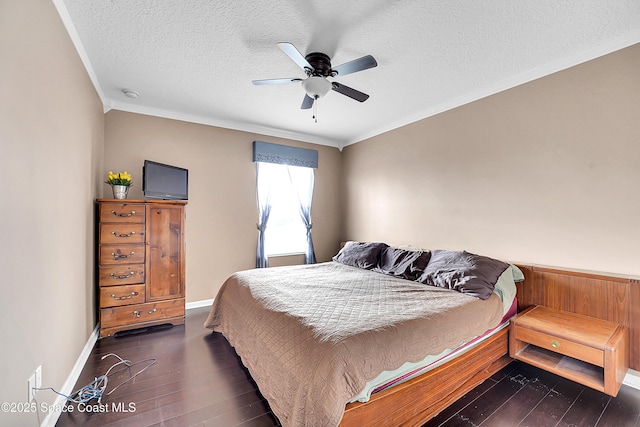 bedroom with ornamental molding, ceiling fan, a textured ceiling, and dark hardwood / wood-style flooring