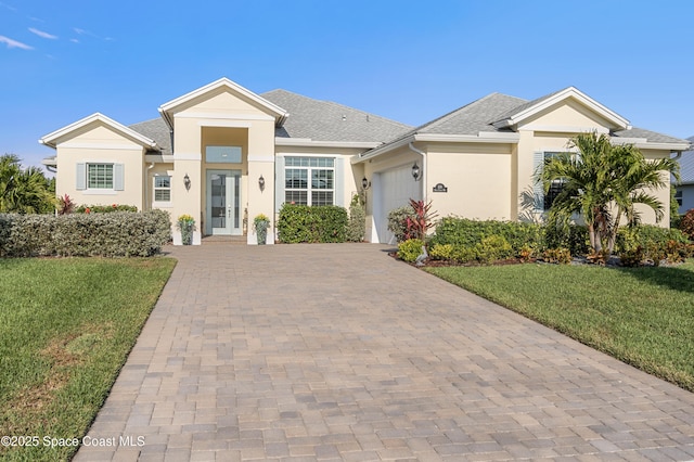 view of front of property with a garage and a front yard