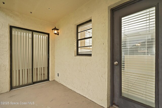 entrance to property with stucco siding